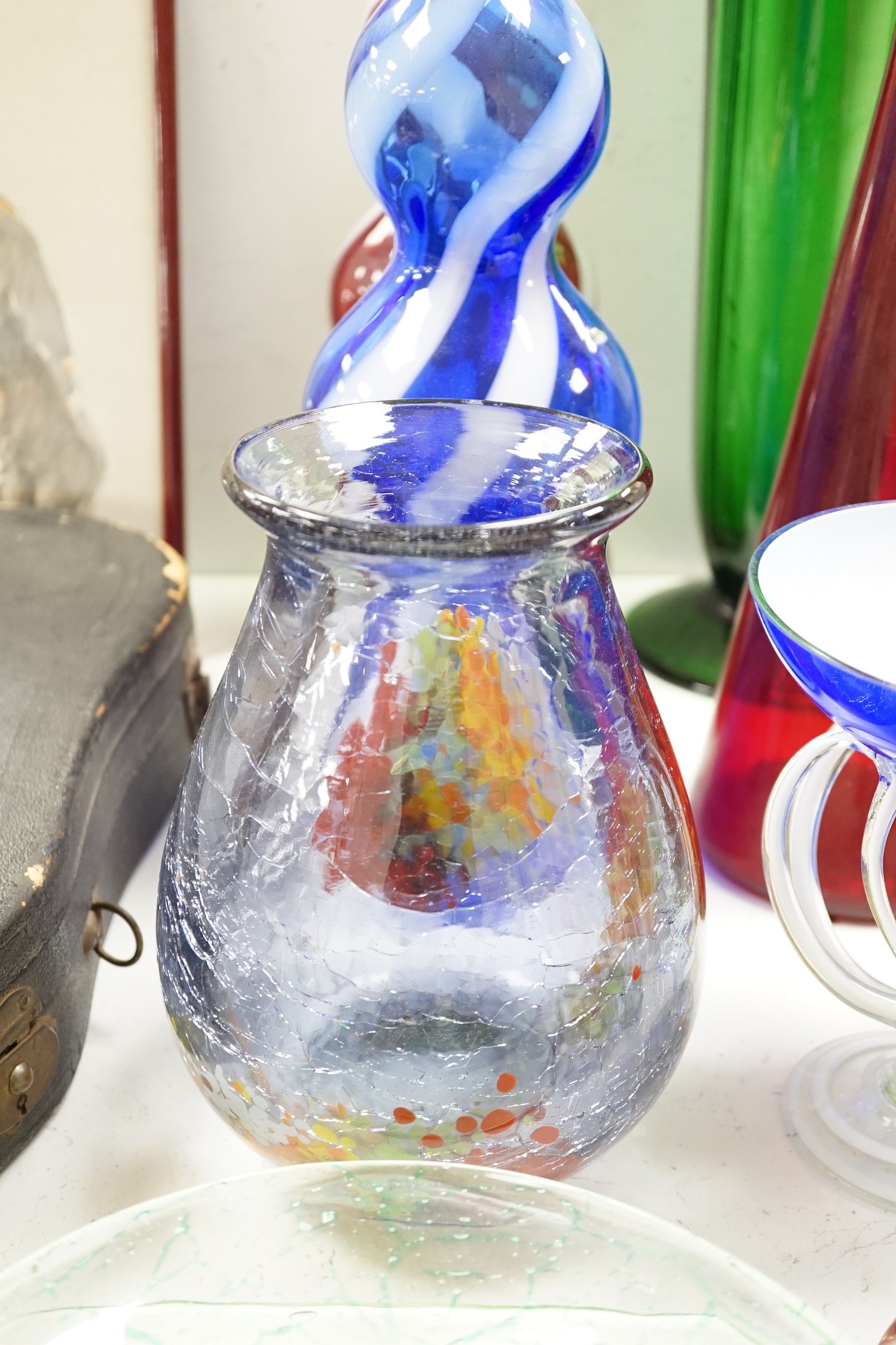 A large group of mixed art glass and other coloured glass vases, bowls, paperweights and two stoppered bottles etc, tallest 65cms high